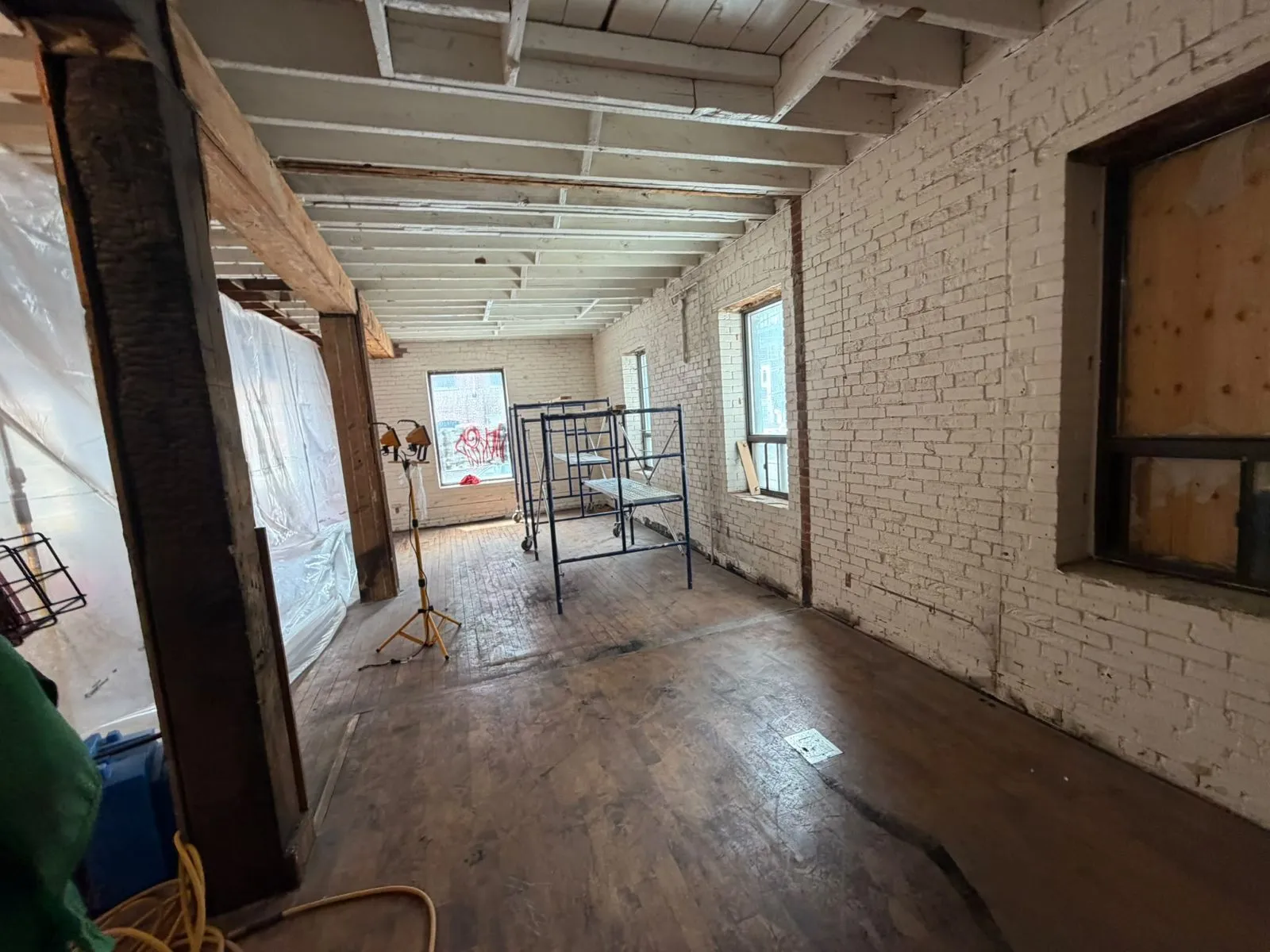 Interior brick and wood beams cleaned by dry ice blasting during a heritage building restoration
