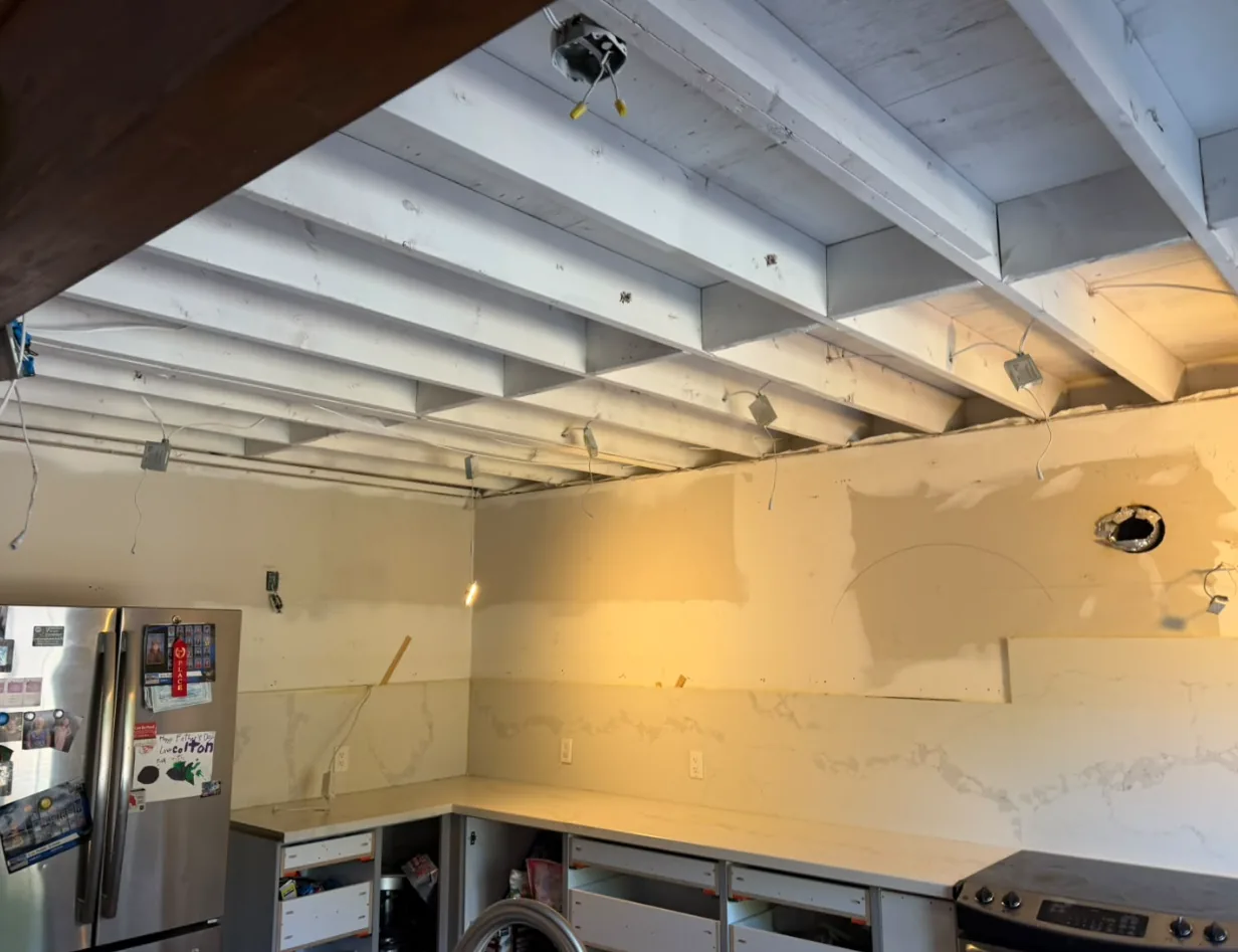 Kitchen ceiling joists cleaned and sealed white after dry ice blasting fire and smoke damage in a GTA home