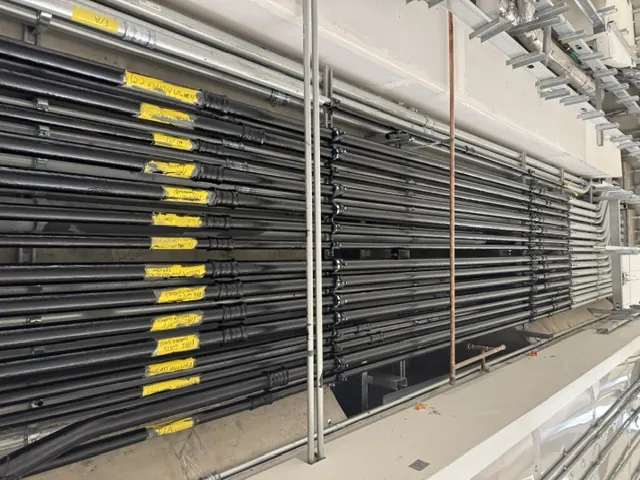 Dustless sandblasting stripping coating from industrial steel racking