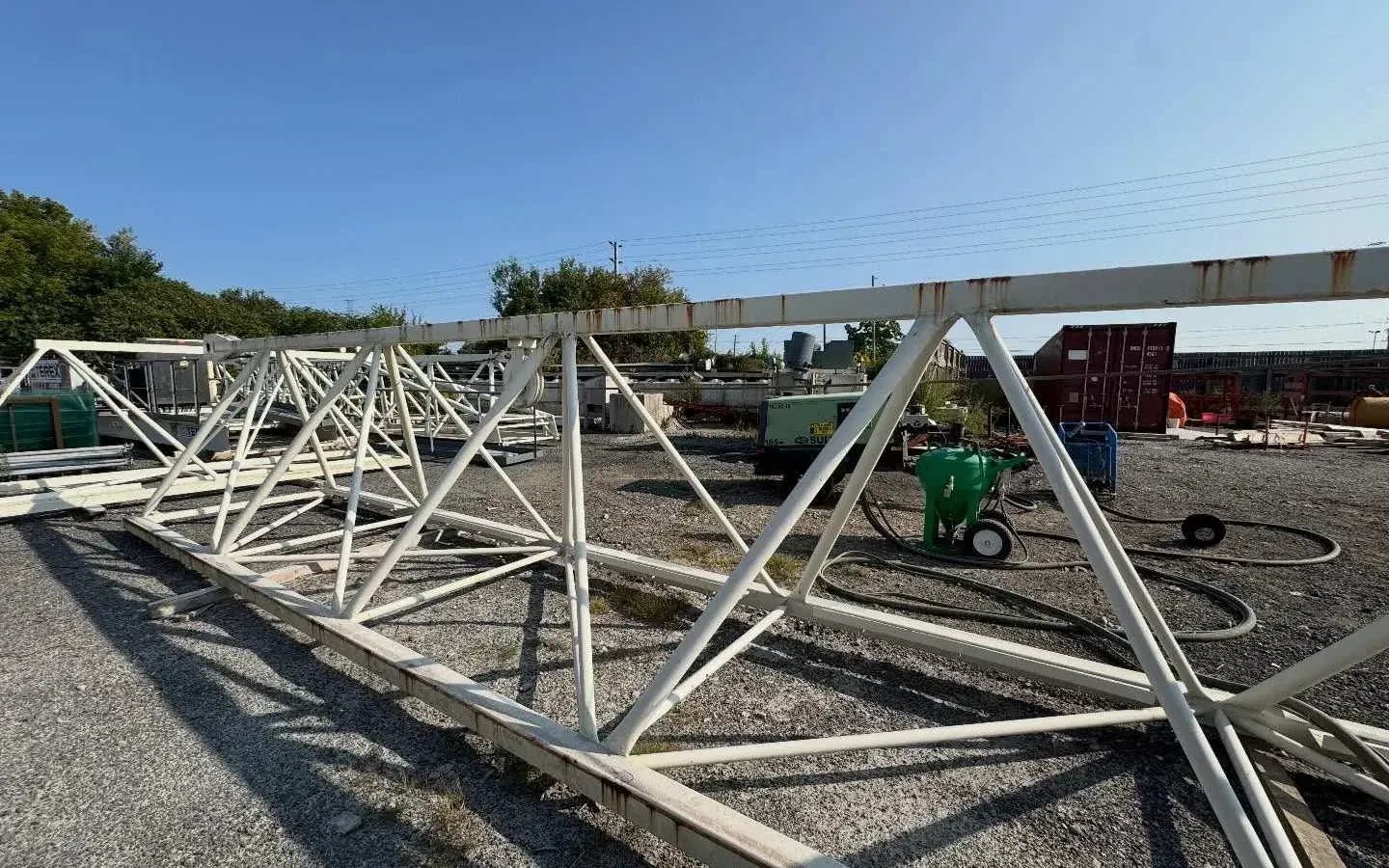 Steel roof trusses sandblasted to clean metal on a GTA yard by Pure Blast Solutions, laid out on blocks and ready for primer