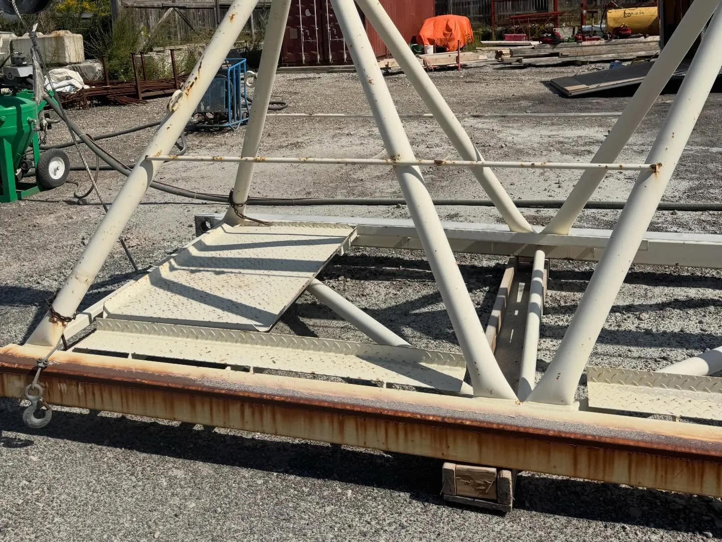 Technician sandblasting a structural steel truss