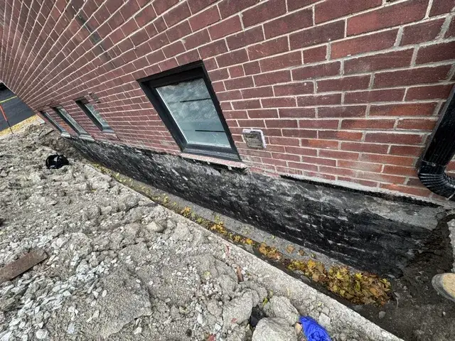 Foundation wall cleaned ahead of waterproof coating