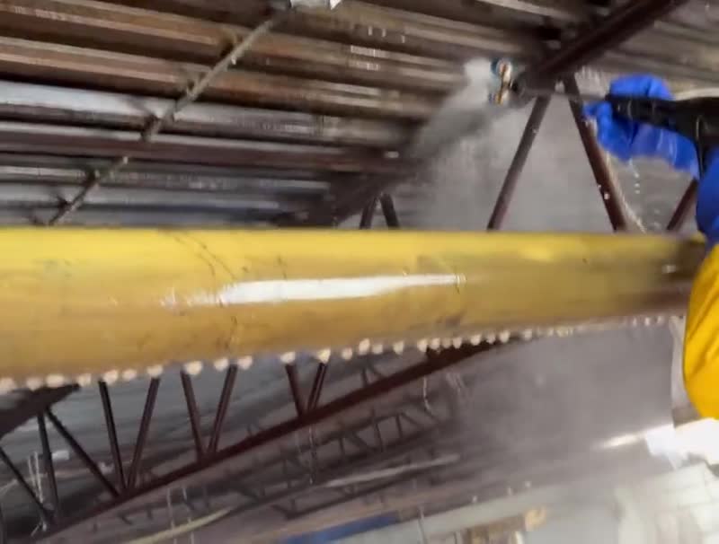 Commercial pressure washing of overhead steel