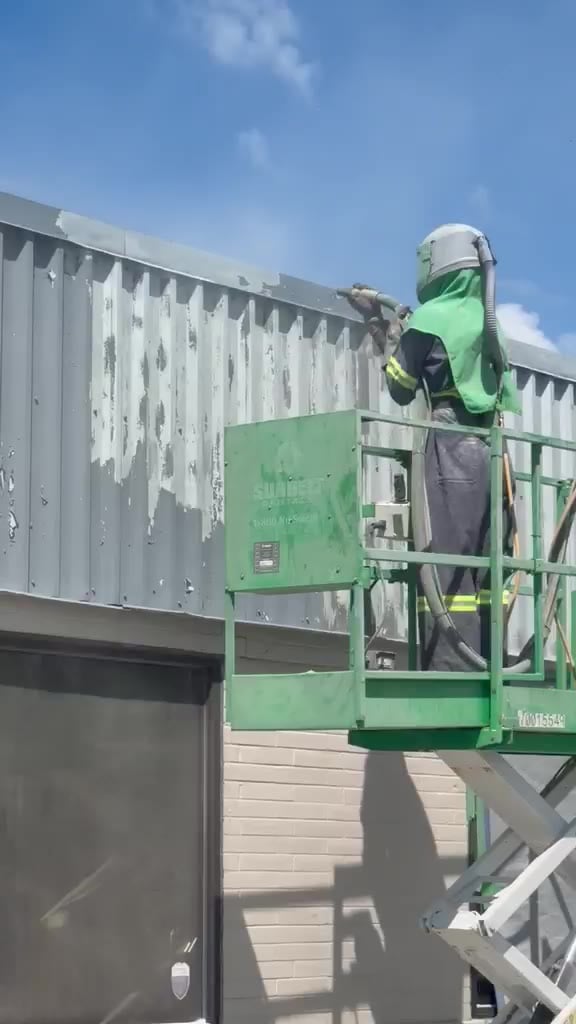 Sandblasting paint off commercial steel cladding